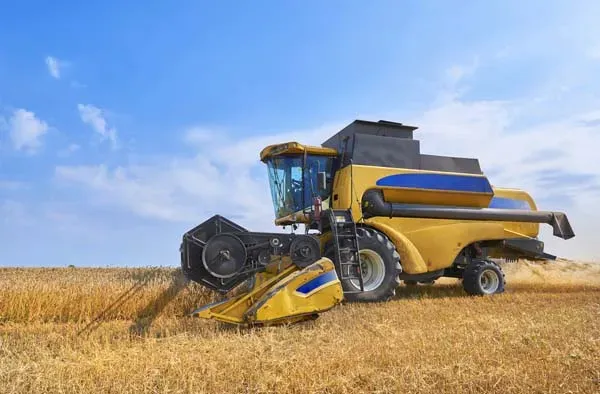 yellow-combine-harvester-in-russian-wheatfield.webp